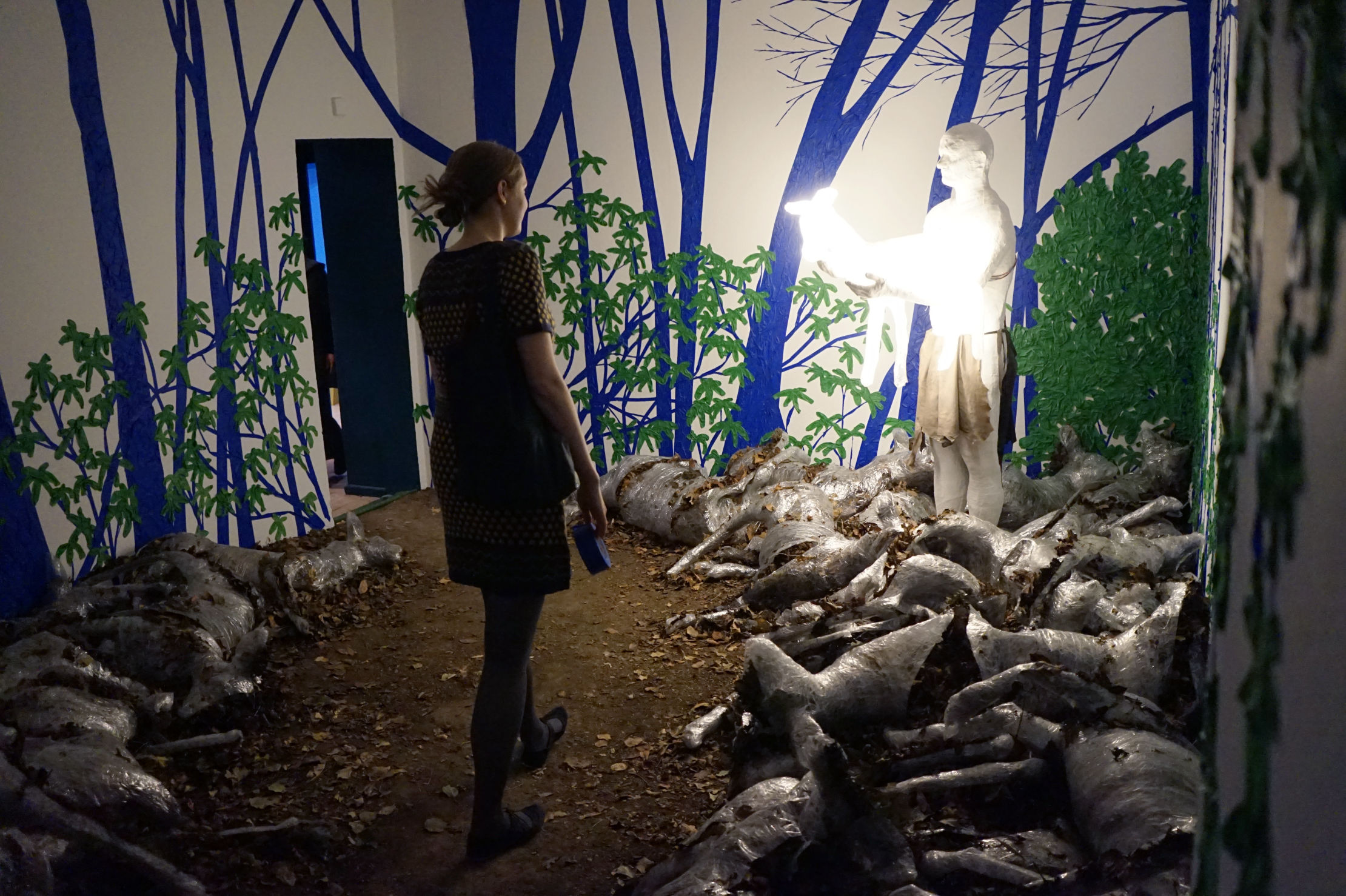 Man holding fawn sculpture.